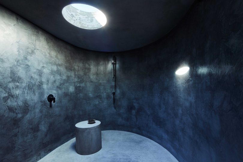 modern interior of dark minimalist bathroom with polished concrete surfaces oval shower room 