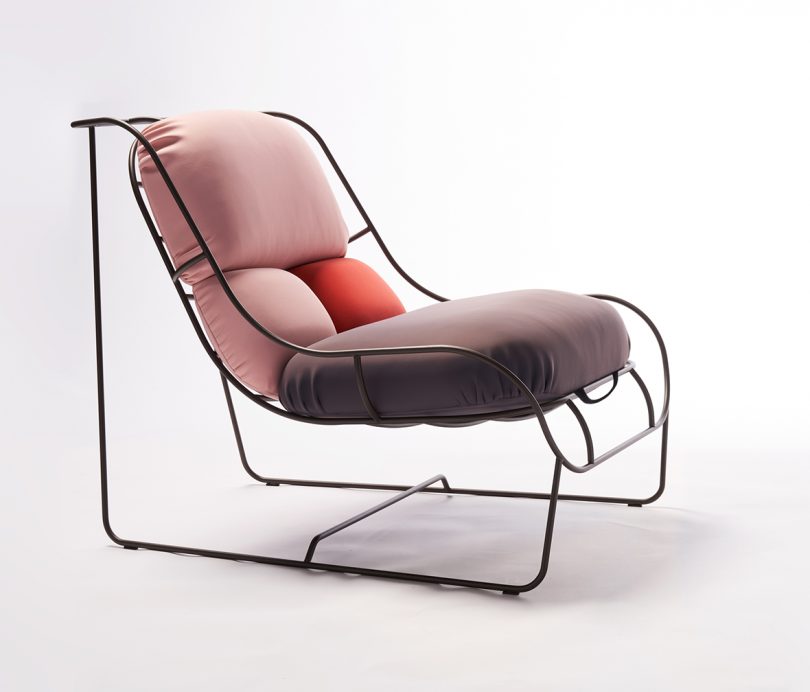 wire framed chair with colorful cushions on white background