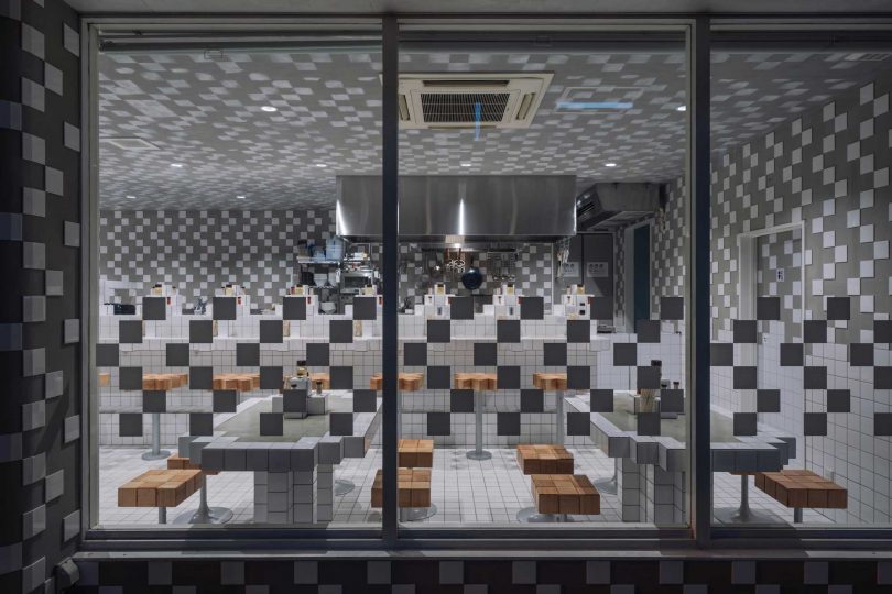 night view looking inside to a restaurant's interior with pixelated design