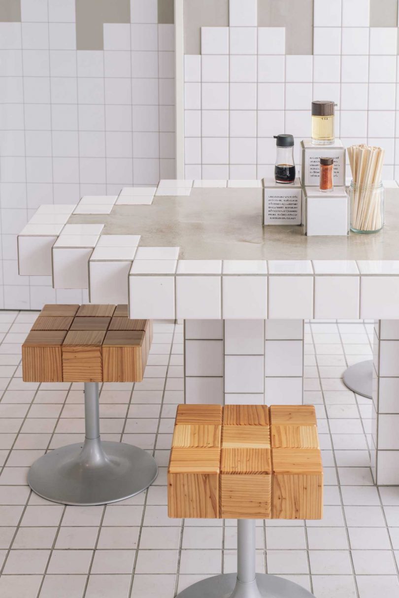 closeup of restaurant interior of tables and stools with pixelated design