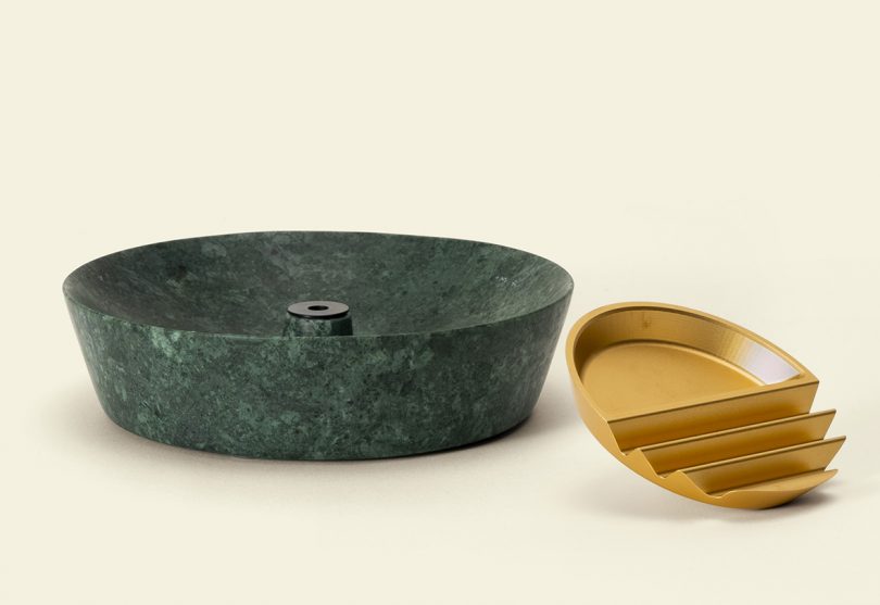 Side view of Ridge ashtray in green marble base with gold aluminum ridged top removed to the side.