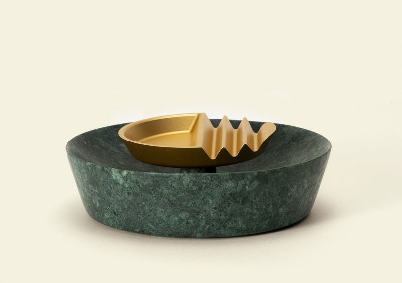 Side view of Ridge ashtray in green marble base with gold aluminum ridged top.