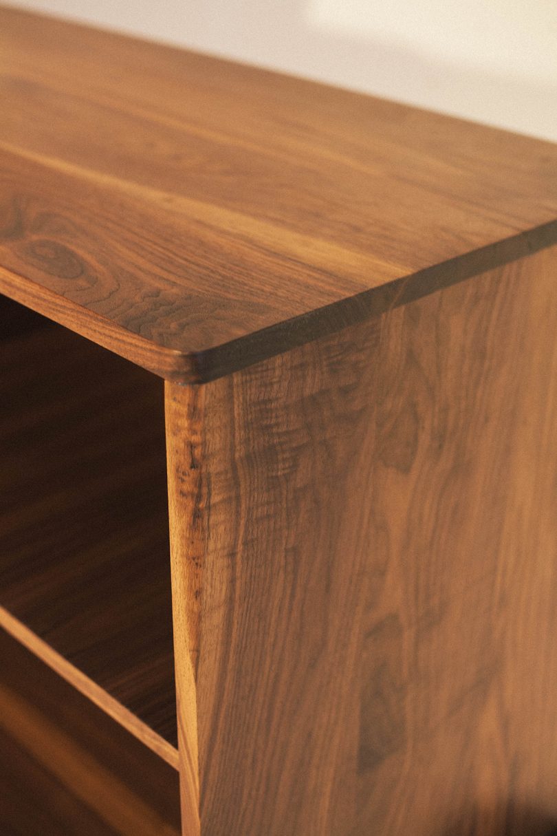 detail of long and low dark wood cabinet