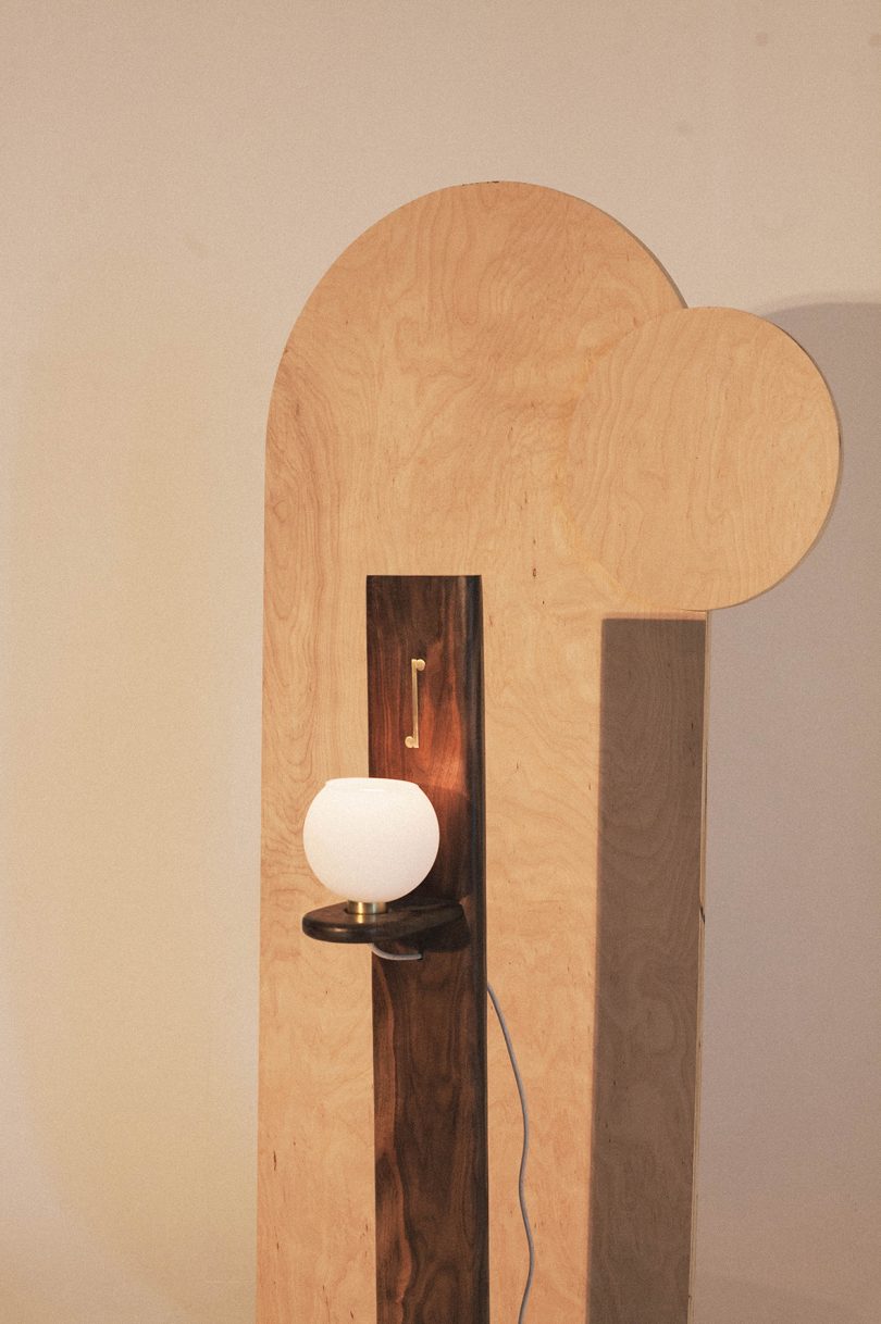 detail of wood floor lamp with globe light