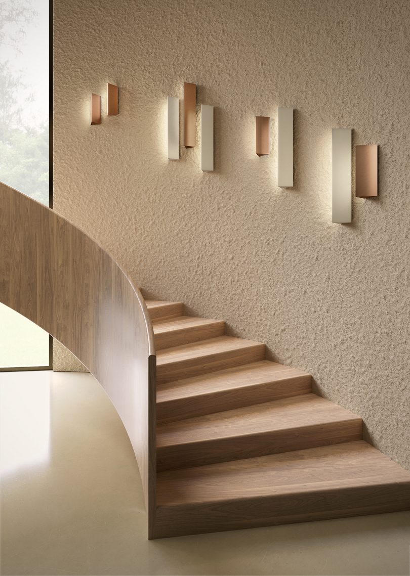 neutral curved staincase with four wall light fixtures