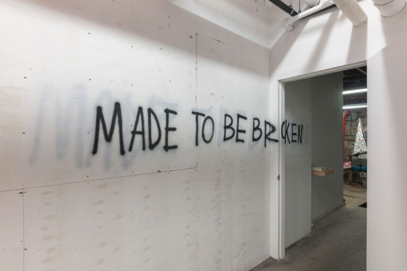 Spray paint text on entry wall of "Made to Be Broken" exhibition