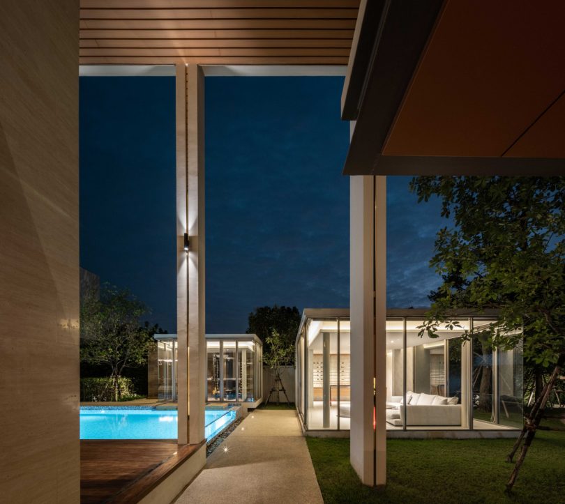 night time shot of modern home courtyard with lit-up pool