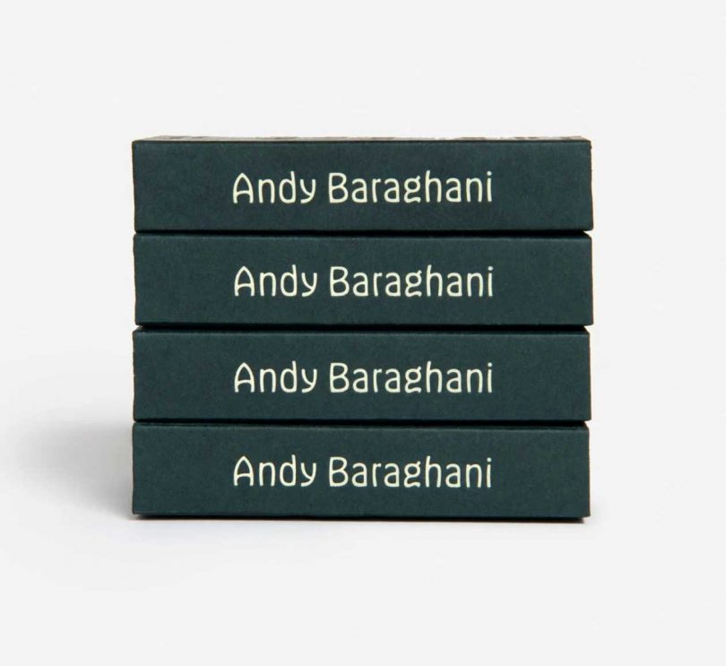 stack of four dark green boxes with the name Andy Baraghani written in white on edges
