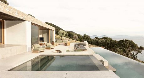 A Modern Greek Villa Built Into the Cliffside Overlooking the Sea