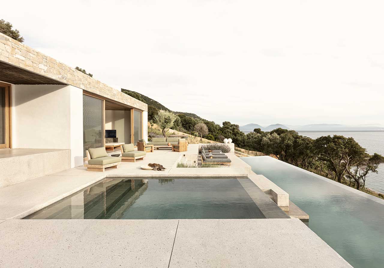 A Modern Greek Villa Built Into the Cliffside Overlooking the Sea
