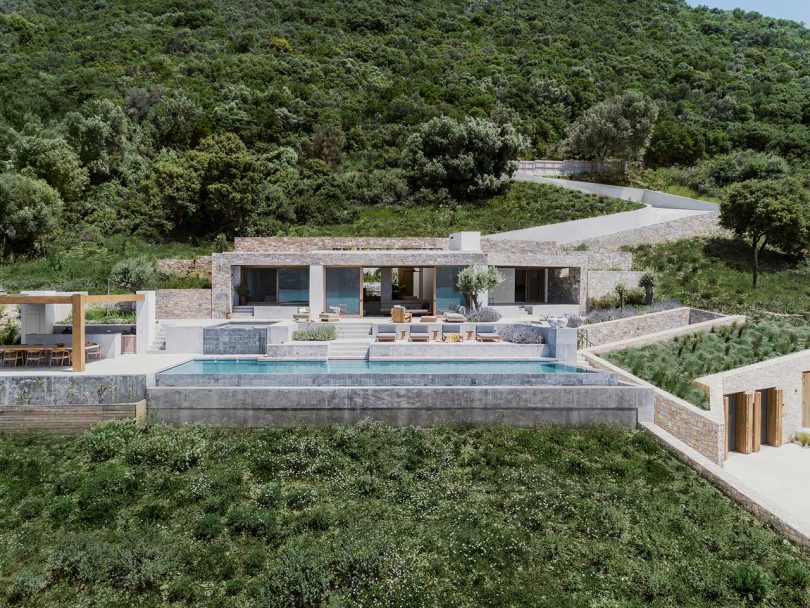 A Modern Greek Villa Built Into the Cliffside Overlooking the Sea