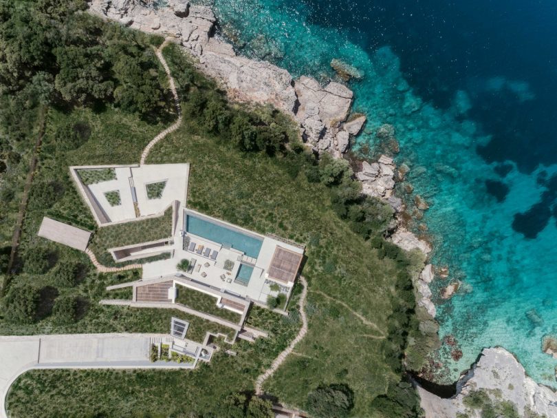 sky view looking down to a modern backyard patio with seating and swimming pool