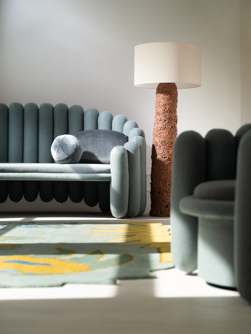 blue grey sofa with brown floor lamp