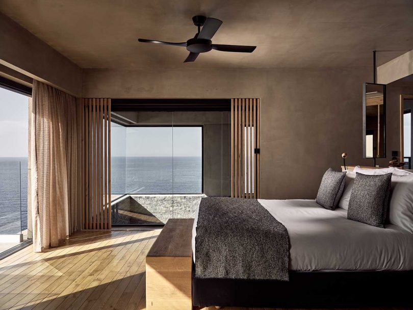 interior view of modern hotel room in neutral furnishings with views to the ocean