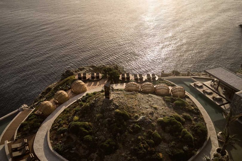 aerial shot of hotel property on rocky cliffside overlooking ocean