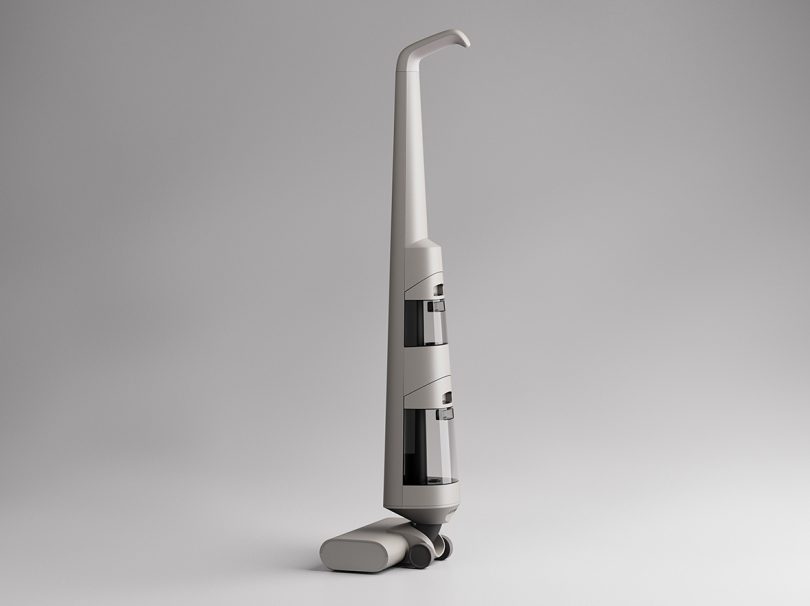 Side-back view of Autoplus vacuum showing two water compartments and tapered handle.