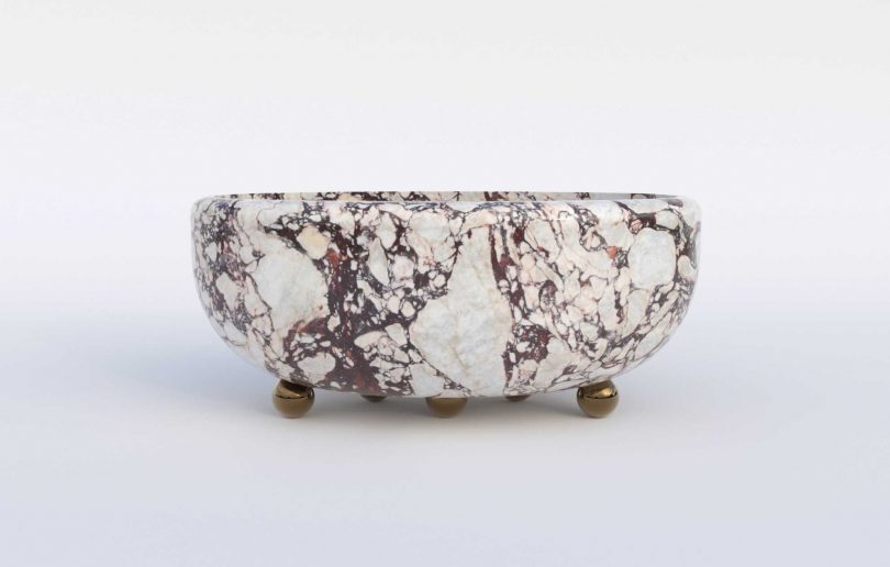 marble and brass bathtub on white background