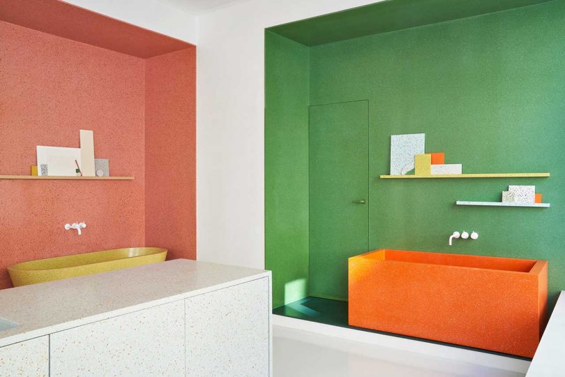 corner view of showroom interior with colorful vignettes showcasing surface material products