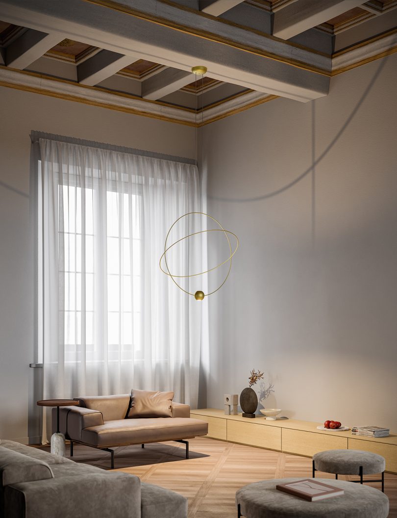 large orbit-like suspension lamp hangs in the middle of a living space