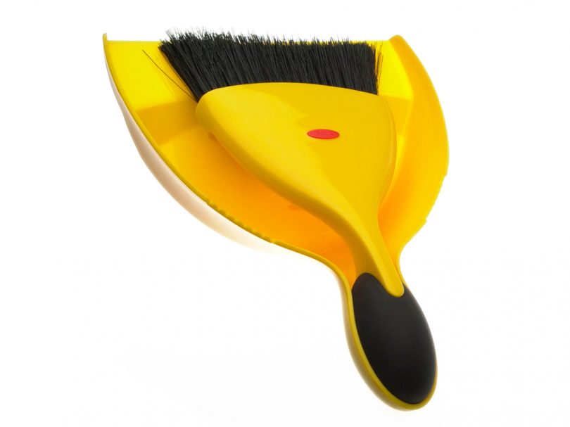 yellow dustpan and brush on white background