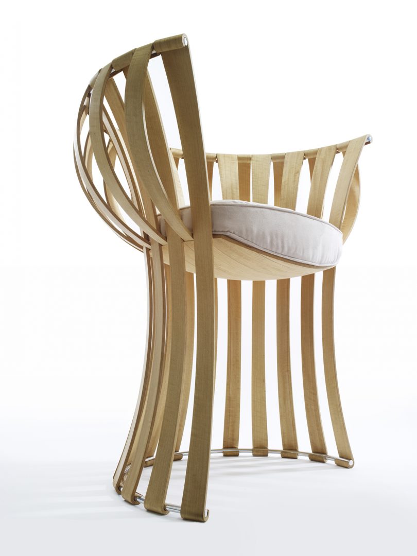 Armchair with wooden slats with upholstered seat on a white background