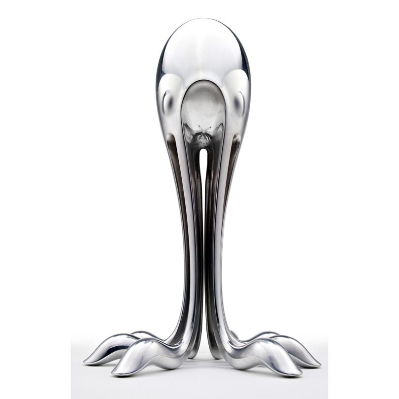 silver sculpture in the shape of a squid on a white background