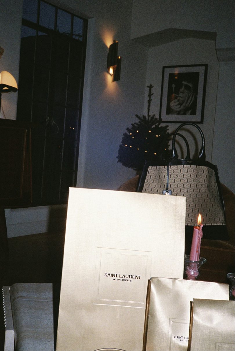 Yves Saint Laurent shopping bags sitting on a table