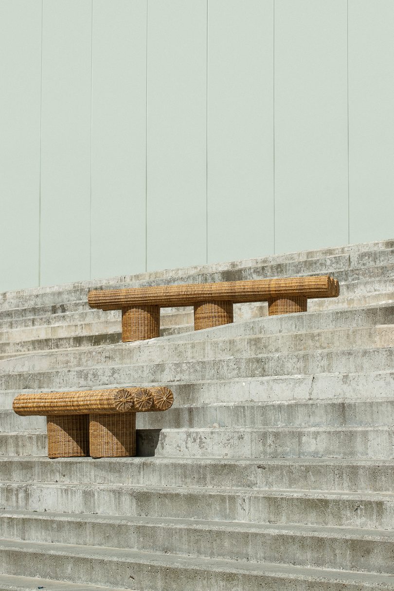 two woven outdoor benches on cement stairs