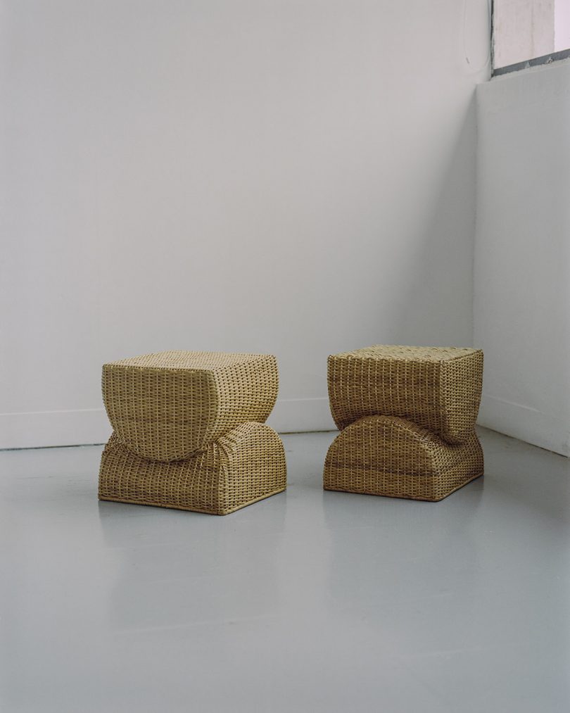 two wicker stools in a white studio
