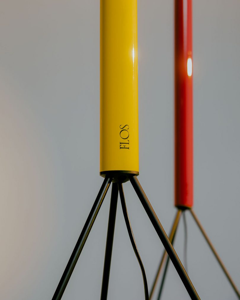 detail of FLOS label on yellow and red slim tripod floor lamps