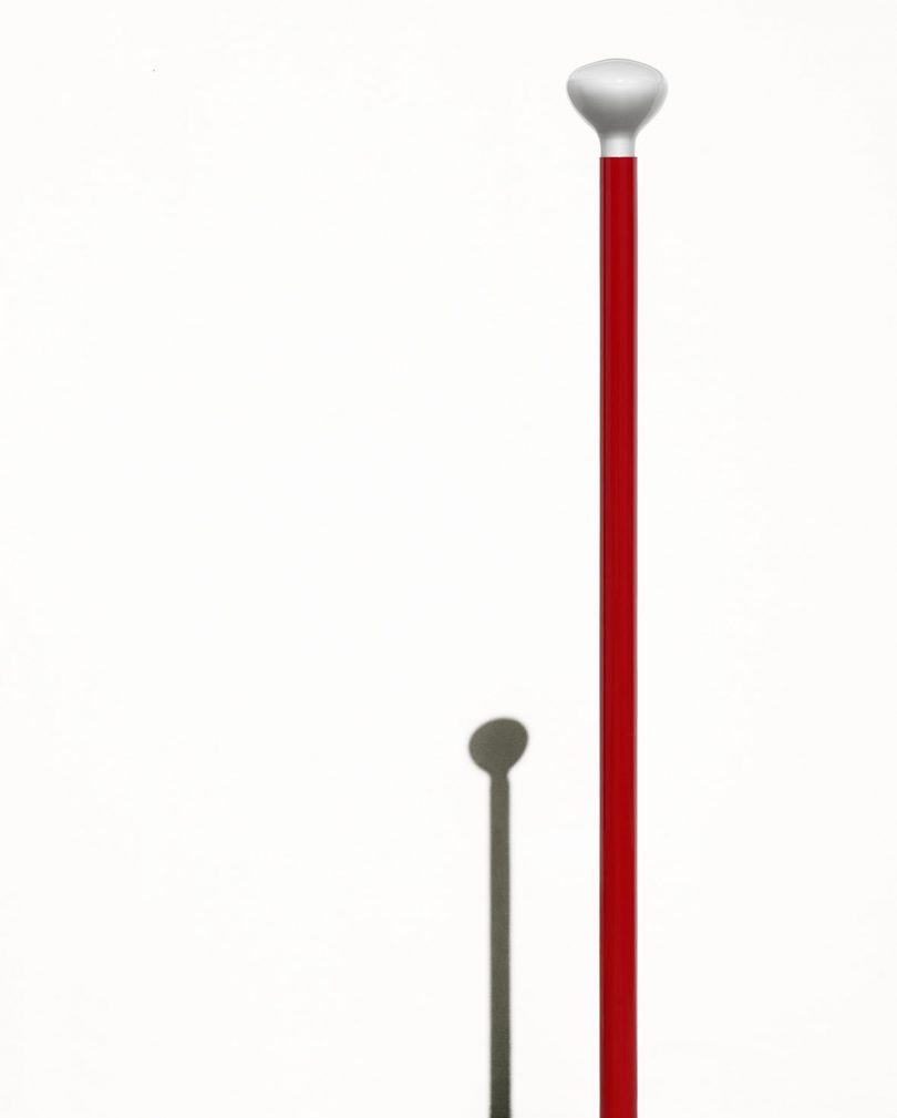 detail of red slim tripod floor lamp
