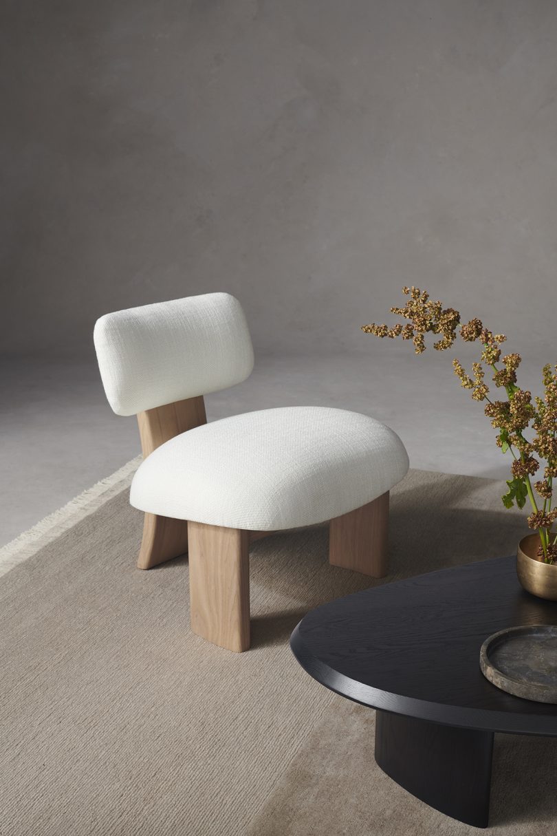 vignette with white upholstered chair with light wood legs
