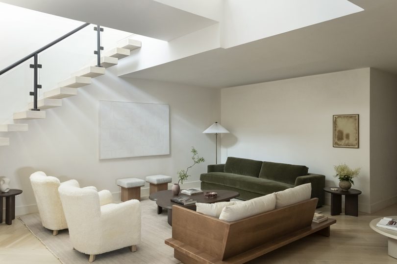 styled living space with two sofas, armchairs, and a floor lamp