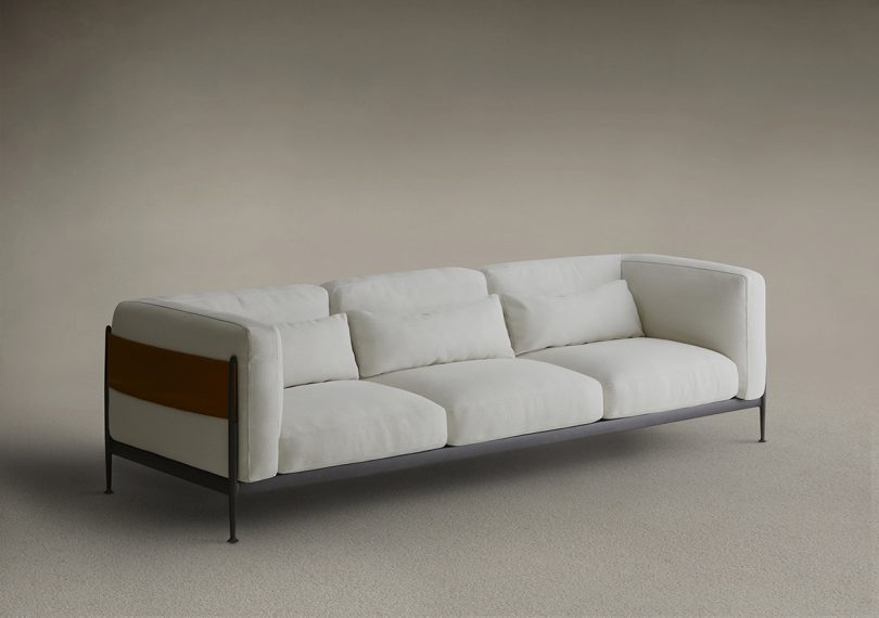 off white 3-seat sofa with black metal structure and surrounding "belt"