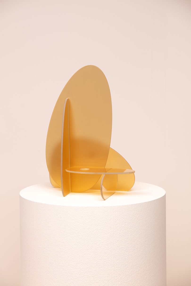 yellow frosted glass candleholder on white plinth