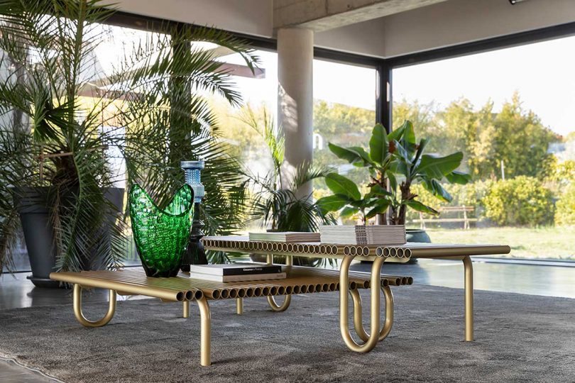 curvaceous gold coffee tables make from pipes in styled living space