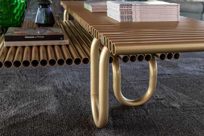 detail of curvaceous gold coffee tables make from pipes
