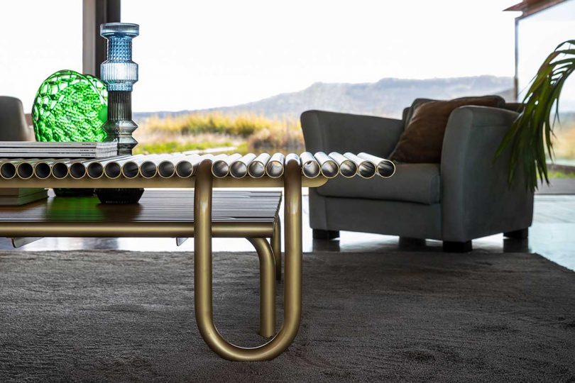 detail of curvaceous gold coffee tables make from pipes