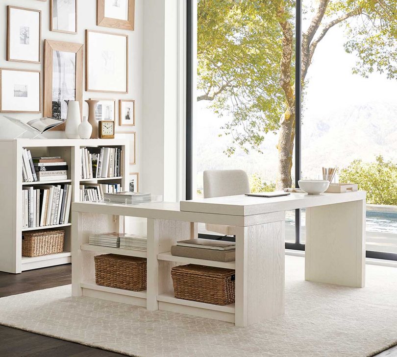 white L-shaped desk in a styled home office space