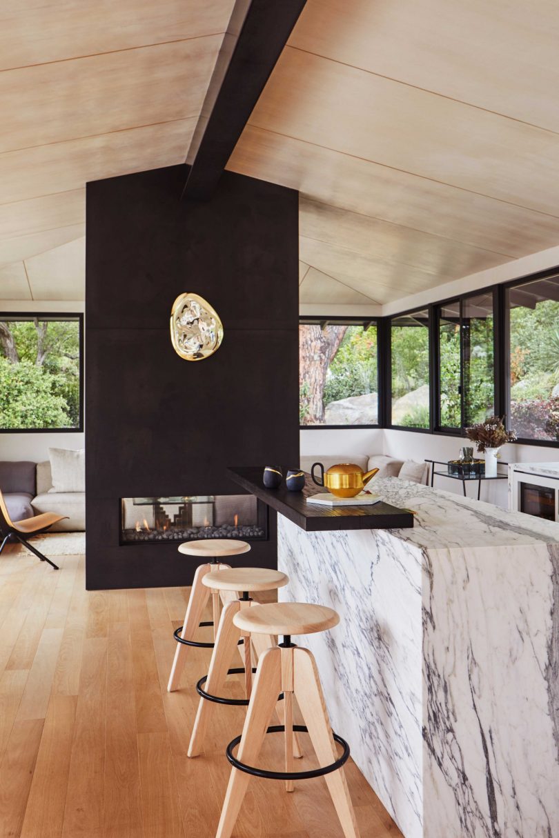 interior view of modern kitchen looking to floating black fireplace