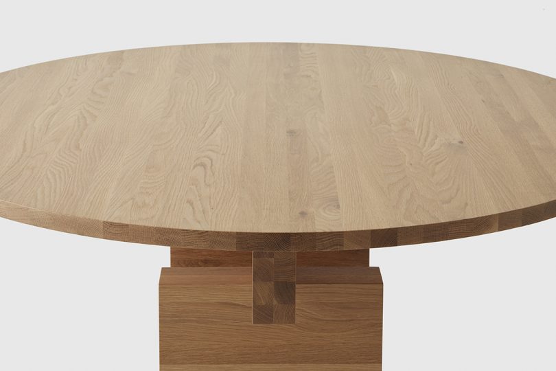 detail of round dining table on white background