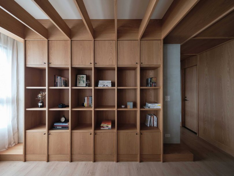 closeup of modern apartment interior of built-in wooden bookcase