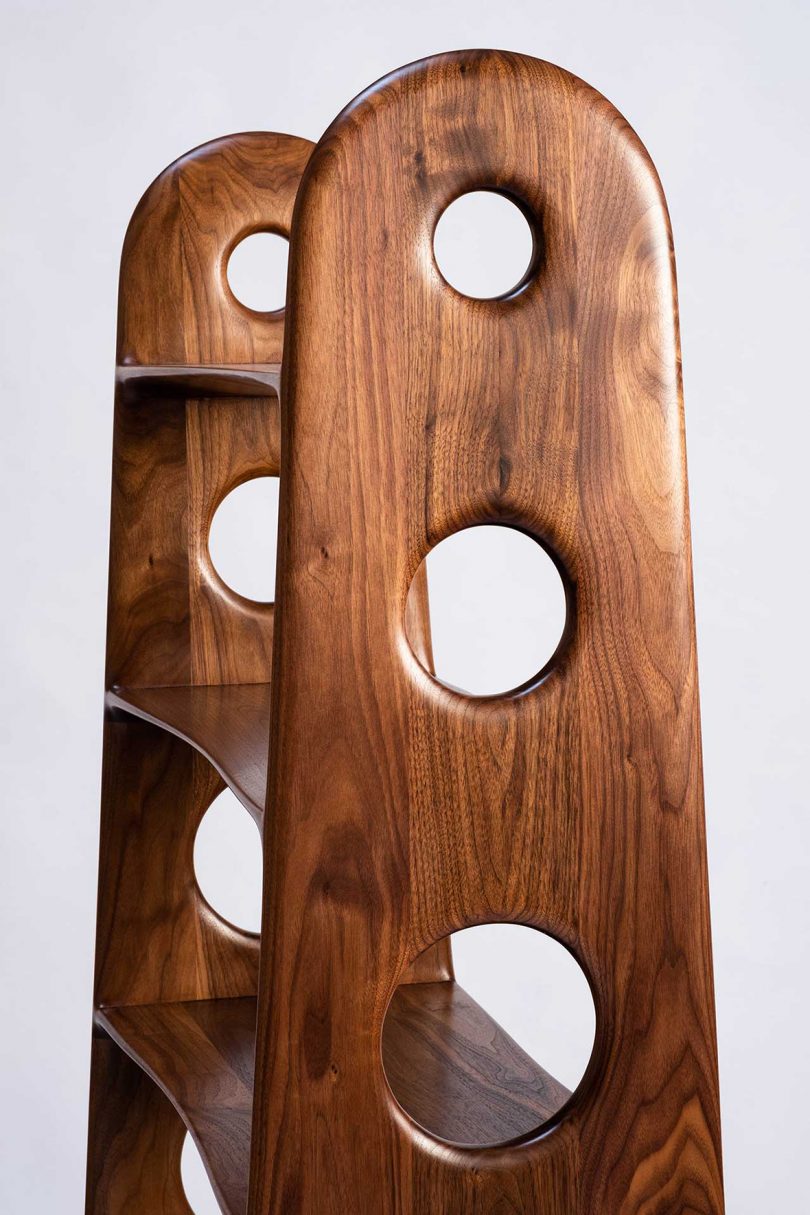 detail of walnut wood bookshelf with circular cutouts on both sides