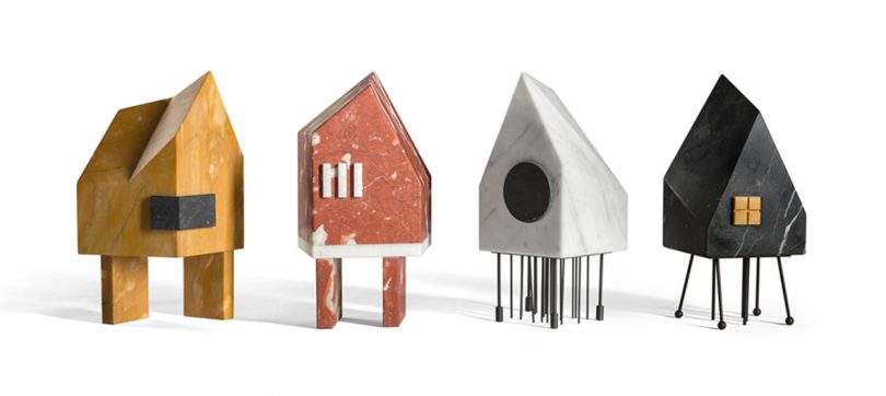four artworks shaped like houses on stilts on a white background
