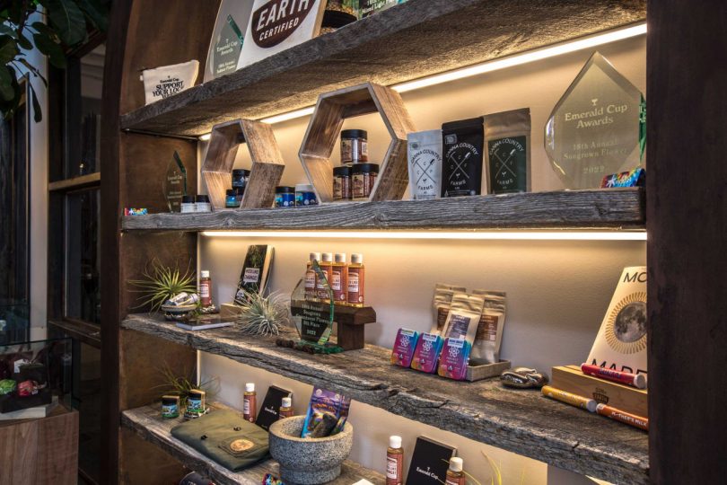closeup of interior of cannabis shop shelf with range of products