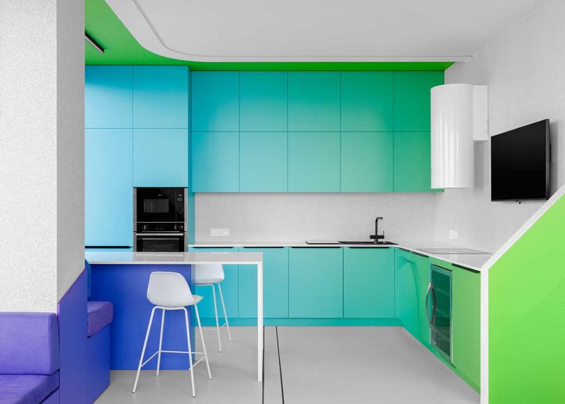A Minimalist Apartment With a Bright Color Gradient Ranging From Green to Purple