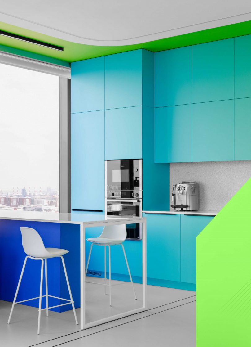 interior view of modern apartment kitchen with bright shades of blue and green