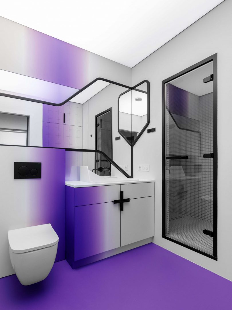 modern bathroom with white walls, graphic black accents, and gradient shades of purple
