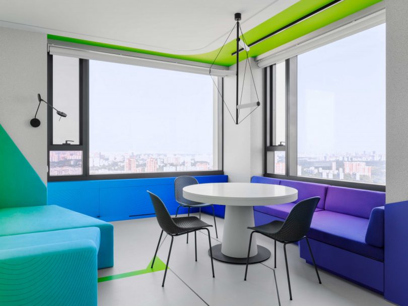 interior view of modern apartment eating area in corner with windows overlooking city