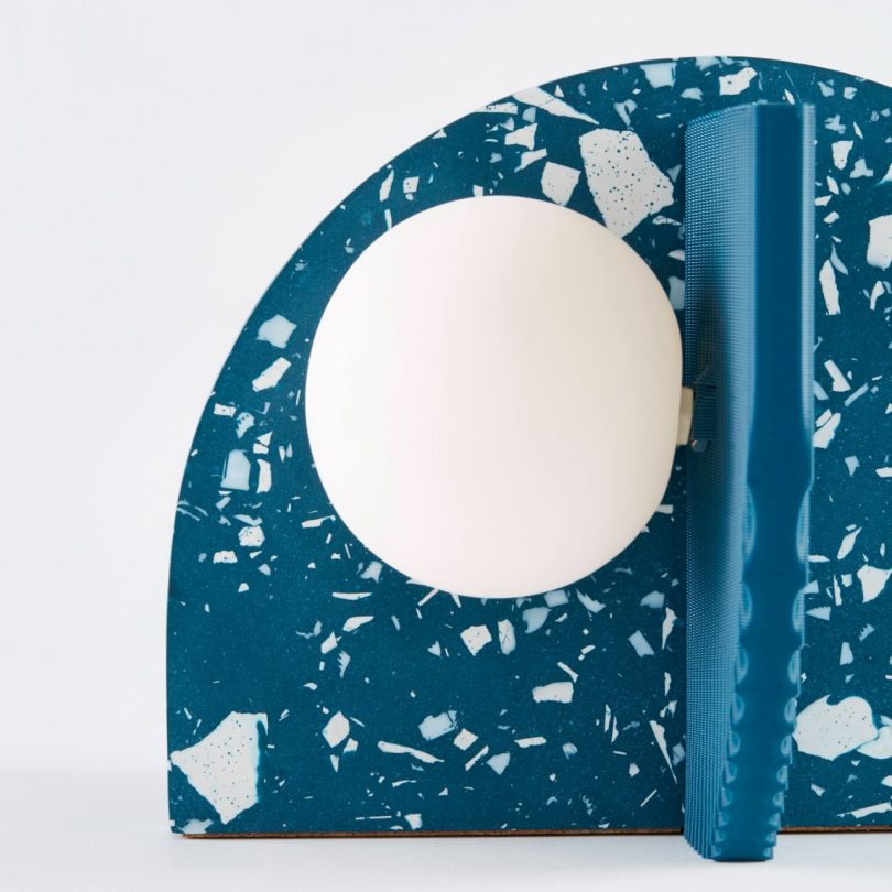 closeup of turquoise blue terrazzo lamp on white backdrop